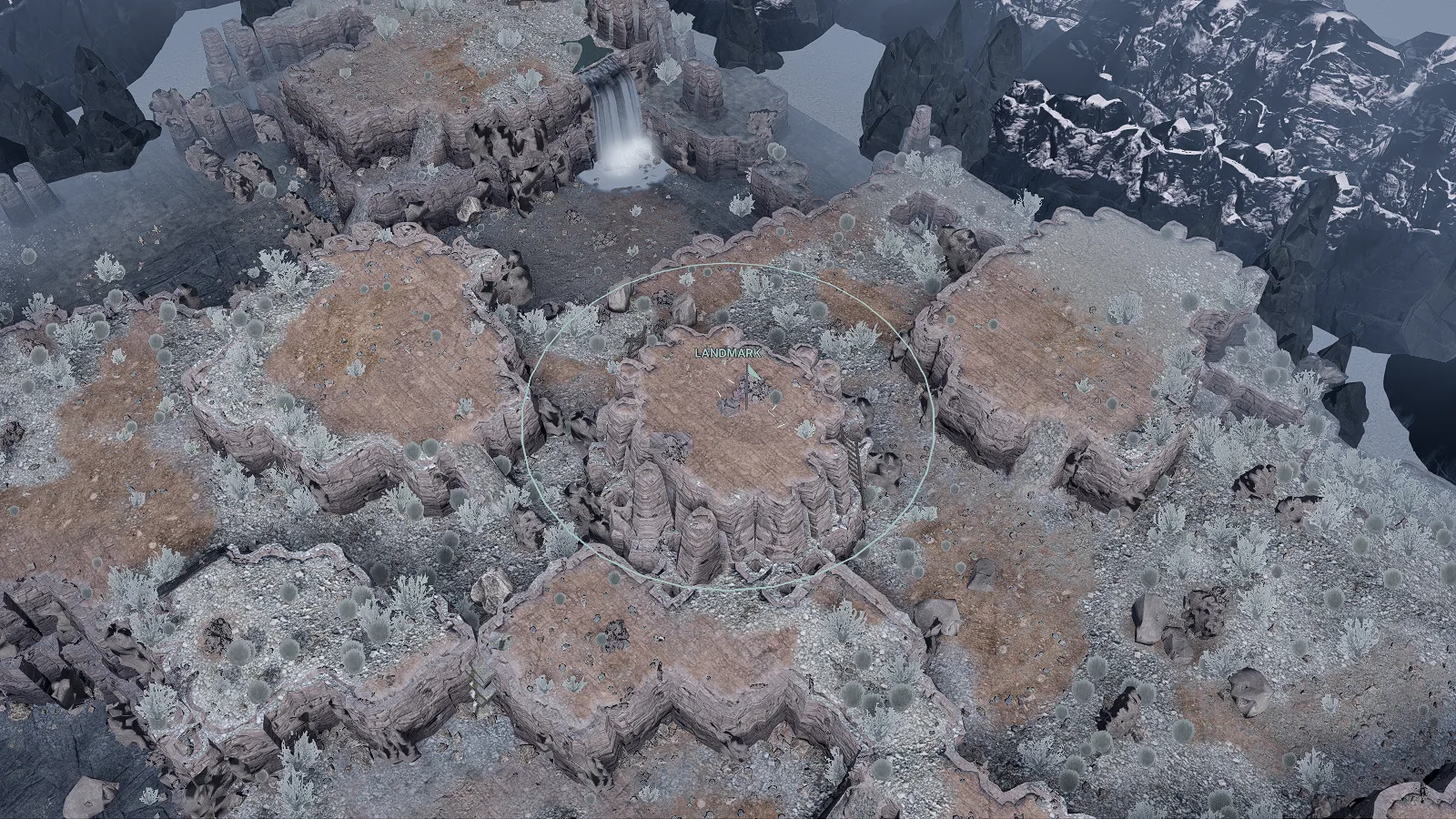A canyon mesa: a round flat-topped stack of rock with a marked landmark on its top, ringed by lower terraces
